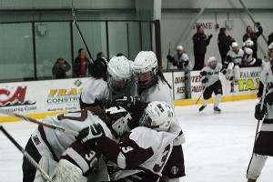 As players fly from the bench and the coaches' cheered, the Falmouth High girls pigpile on top of senior captain and goalie Maddie Scavotto after defeating Barnstable last night, 2-0, to take home the SEMGHAL Coastal championship title. Sean Walsh/Capecod.com sports