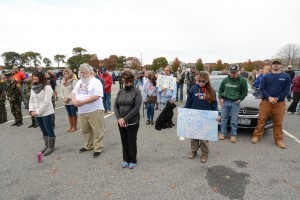 CCB MEDIA PHOTO A crowd bows heads at the Dennis-Yarmouth Regional High School parking log Saturday in support of local law enforcement