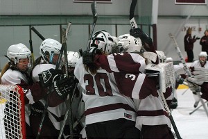 Falmouth goalie Maddie Scavotto is swarmed by teammates at the end of the game. Sean Walsh/Capecod.com Sports 