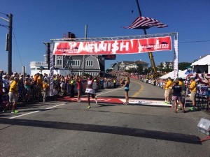 COURTESY OF THE FALMOUTH ROAD RACE Diane Nukuri crosses the finish line as the winner of the women's field at the 43rd Falmouth Road Race.